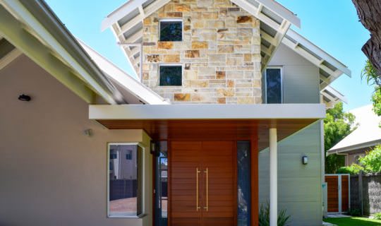 external shot of a residential build in dunsborough highlighting the stone feature wall and timber roof cladding